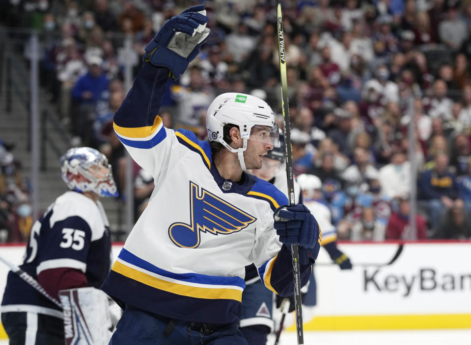 St. Louis Blues left wing Brandon Saad, front, celebrates after left wing David Perron scored a goal past Colorado Avalanche goaltender Darcy Kuemper, back, in the second period of an NHL hockey game Saturday, Oct. 16, 2021, in Denver. (AP Photo/David Zalubowski)