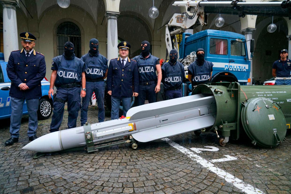 Police stand by a missile seized at an airport hangar near Pavia, northern Italy, following an investigation into Italians who took part in the Russian-backed insurgency in eastern Ukraine.