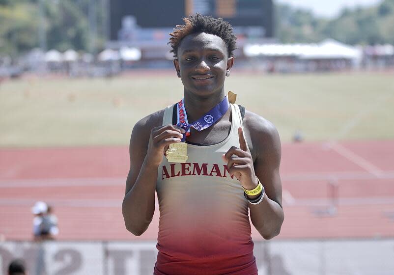 Bishop Alemany freshman Demare Dezeurn displays his medal.