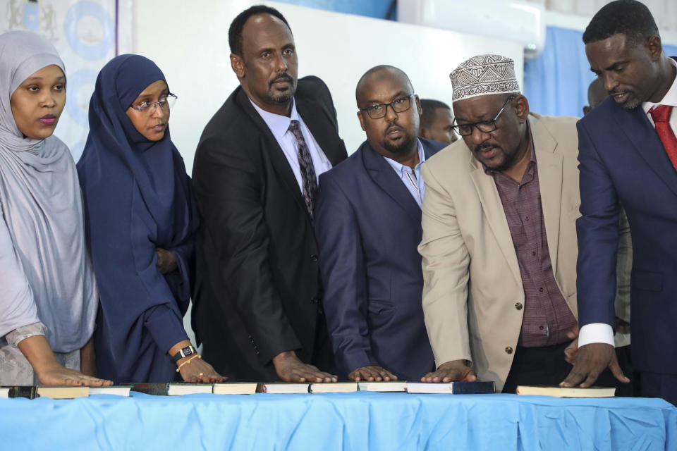 Somali lawmakers are sworn-in to office at a ceremony held in the capital's heavily fortified Halane military camp, in Mogadishu, Somalia Thursday, April 14, 2022. Somalia on Thursday inaugurated 290 new lawmakers, bringing the country a step closer to completing a prolonged electoral process marred by alleged corruption and irregularities. (AP Photo/Farah Abdi Warsameh)