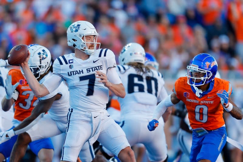 Utah State quarterback Spencer Petras (7) is pressured as he throws the ball by Boise State safety Ty Benefield (0) in the first half of an NCAA college football game, Saturday, Oct. 5, 2024, in Boise, Idaho. . (AP Photo/Steve Conner) | Steve Conner