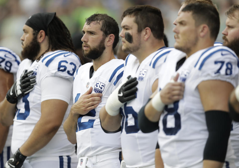 Indianapolis Colts players, including quarterback Andrew Luck, second from left, stand during the singing of the national anthem before an NFL football preseason game against the Seattle Seahawks, Thursday, Aug. 9, 2018, in Seattle. (AP Photo/Stephen Brashear)