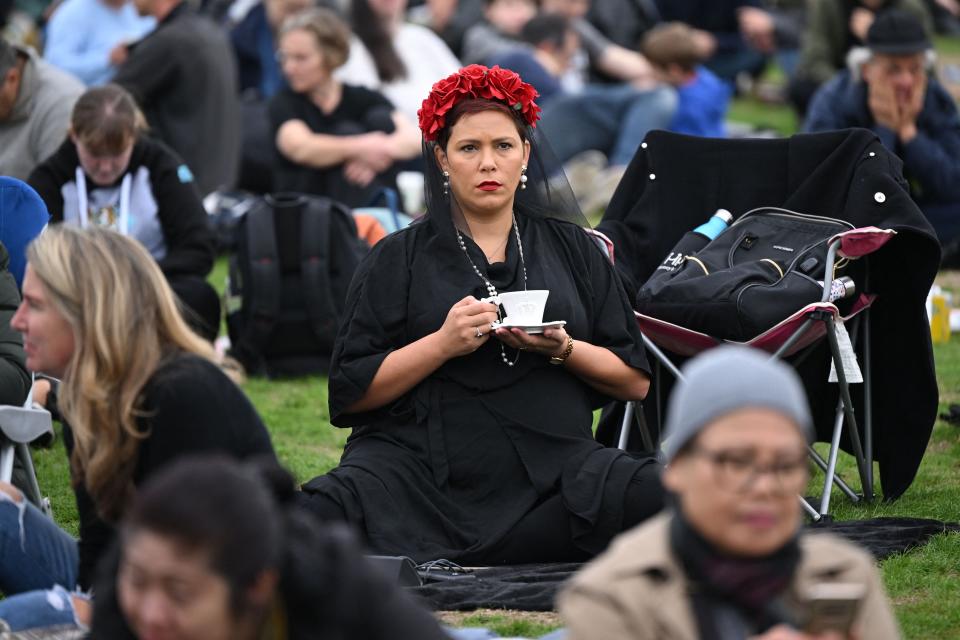 A well-wisher waits in Hyde Park where the funeral of Queen Elizabeth II was shown on a large screen in London on Sept. 19, 2022.