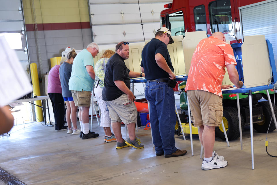 Voters cast their ballots at the Western Lakes fire station in Oconomowoc, Wis.