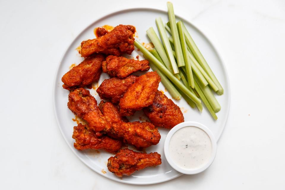 Two key steps ensure extra-crisp wings: letting them sit at room temperature evens the cooking time, and the cornstarch dredge transforms into a crunchy shell when fried. If you like your wing sauce super spicy, increase the amount of cayenne.