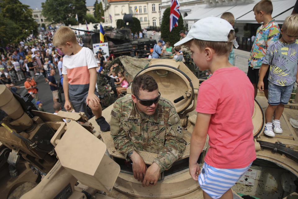 People attend a military picnic marking the Polish Army Day in Warsaw, Poland, Monday, Aug. 15, 2022. The Polish president and other officials marked their nation's Armed Forces Day holiday Monday alongside the U.S. army commander in Europe and regular American troops, a symbolic underlining of NATO support for members on the eastern front as Russia wages war nearby in Ukraine. (AP Photo/Michal Dyjuk)