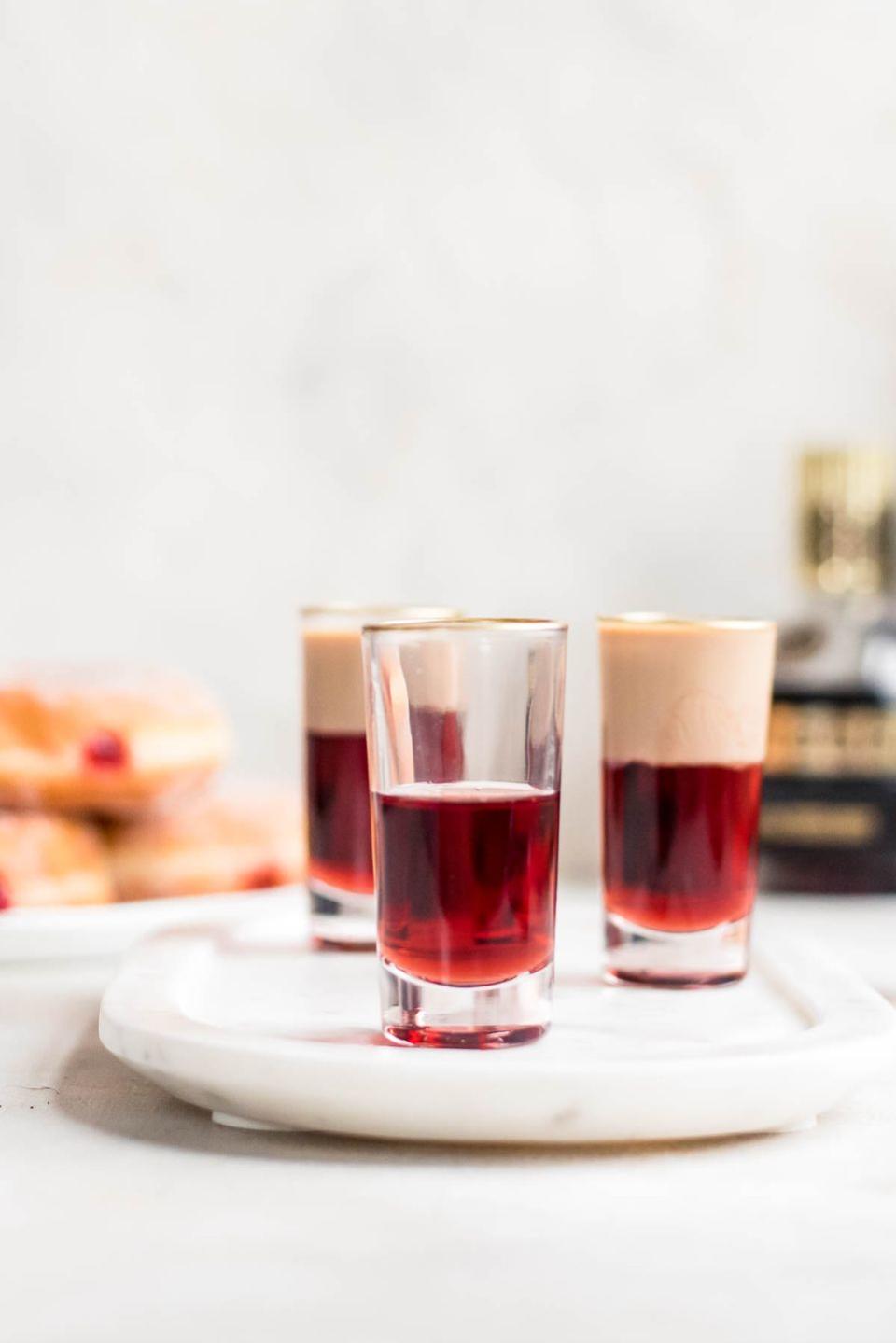 jelly donut shot on white marble tray