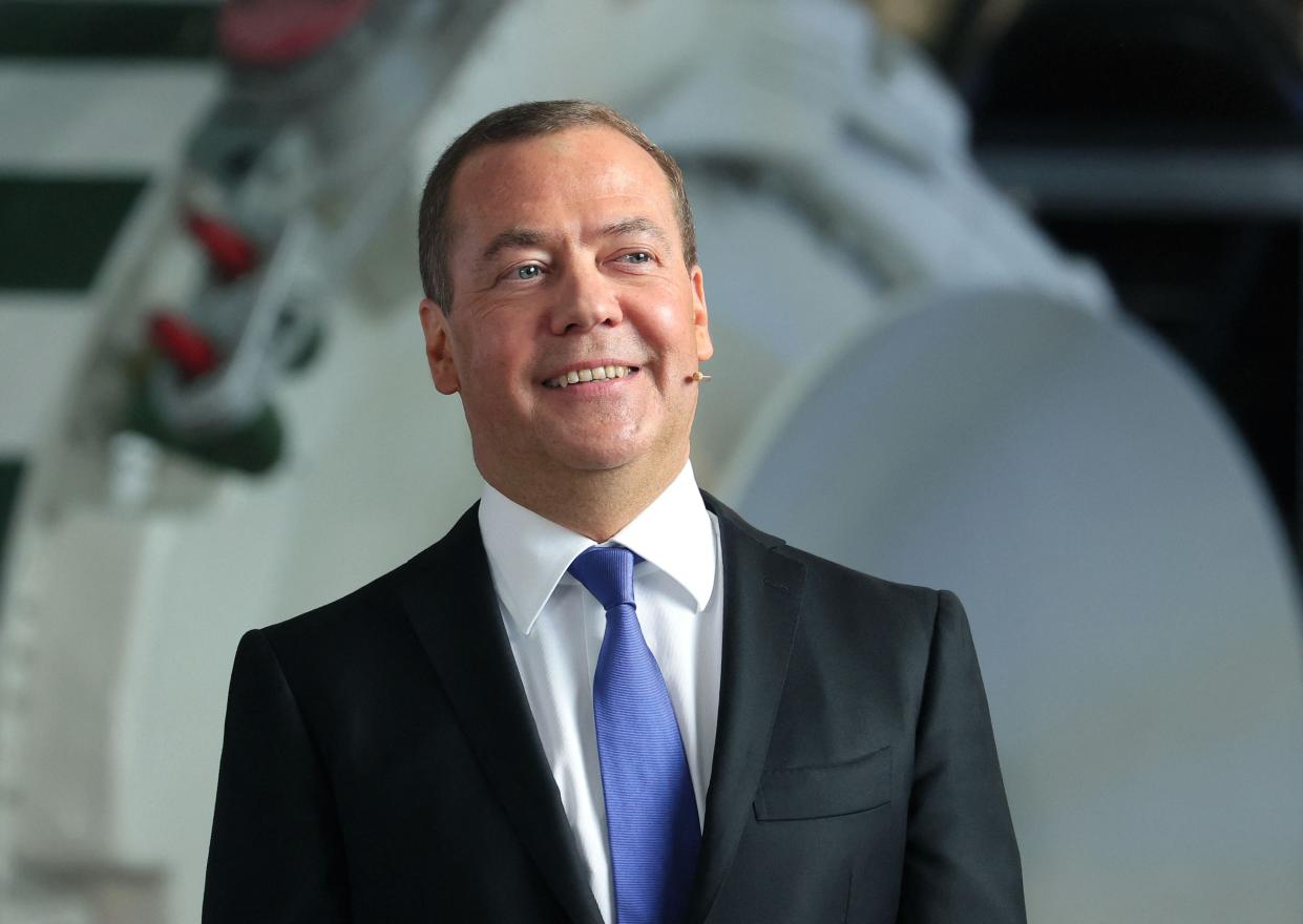 Russia’s former leader Dmitry Medvedev, a President Putin ally who is now deputy chairman of the country’s security council, meets with staff members during his visit to the military-industrial corporation NPO Mashinostroyenia in Reutov, outside Moscow, on 25 April 2023 (AFP via Getty Images)