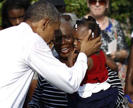 U.S. President Barack Obama shares a moment with Zoey Komongnan and her grandmother Mary at an event commemorating the 12th anniversary of the 9/11 attacks at the Pentagon near Washington, September 11, 2013. REUTERS/Jason Reed