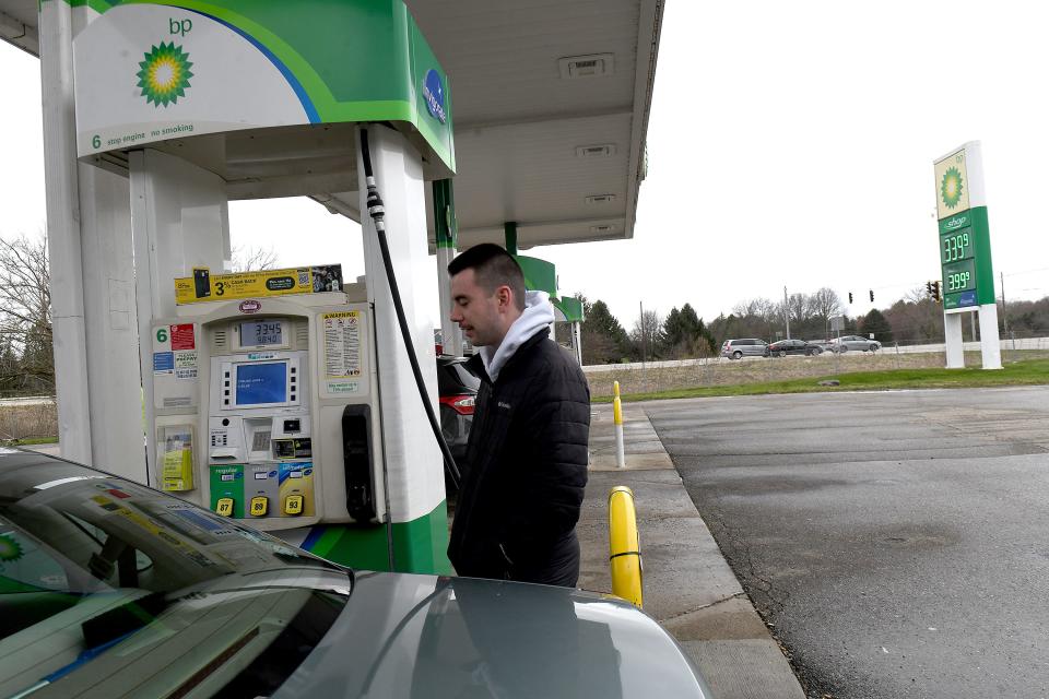 Nathan Davis of Doylestown puts gas in his car at Doylestown Food Mart located at the intersection of state Route 21 and Edwards Road in Doylestown. He said it is his regular gas station because of low prices. He's unsure how upcoming improvements to Route 21 may interfere with his travel.