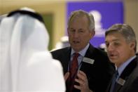Boeing Chairman James McNerney and Boeing Commercial Airplanes Chief Executive Ray Conner (R) speak with a visitor during the Dubai Airshow November 18, 2013. REUTERS/Caren Firouz
