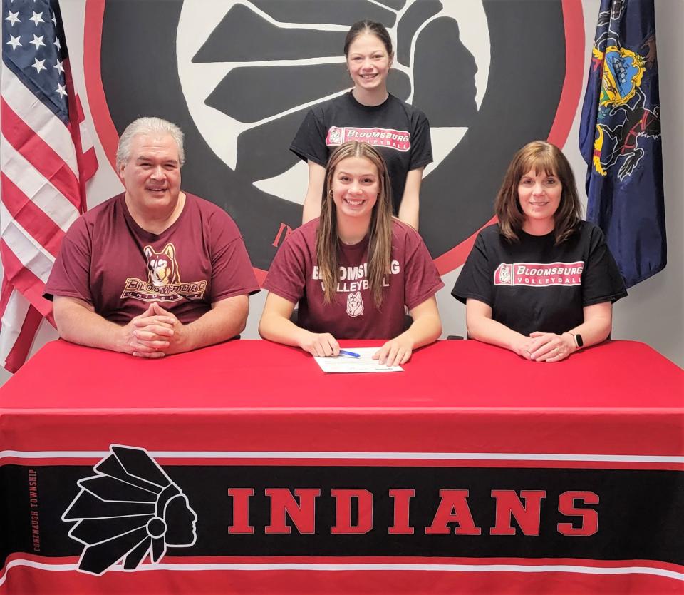 Flanked by parents Mike and Laura Swank, Conemaugh Township senior Hannah Swank signs a National Letter of Intent to attend and play volleyball at Bloomsburg University, May 23, in Davidsville. In back is Swank's sister Sarah Swank.