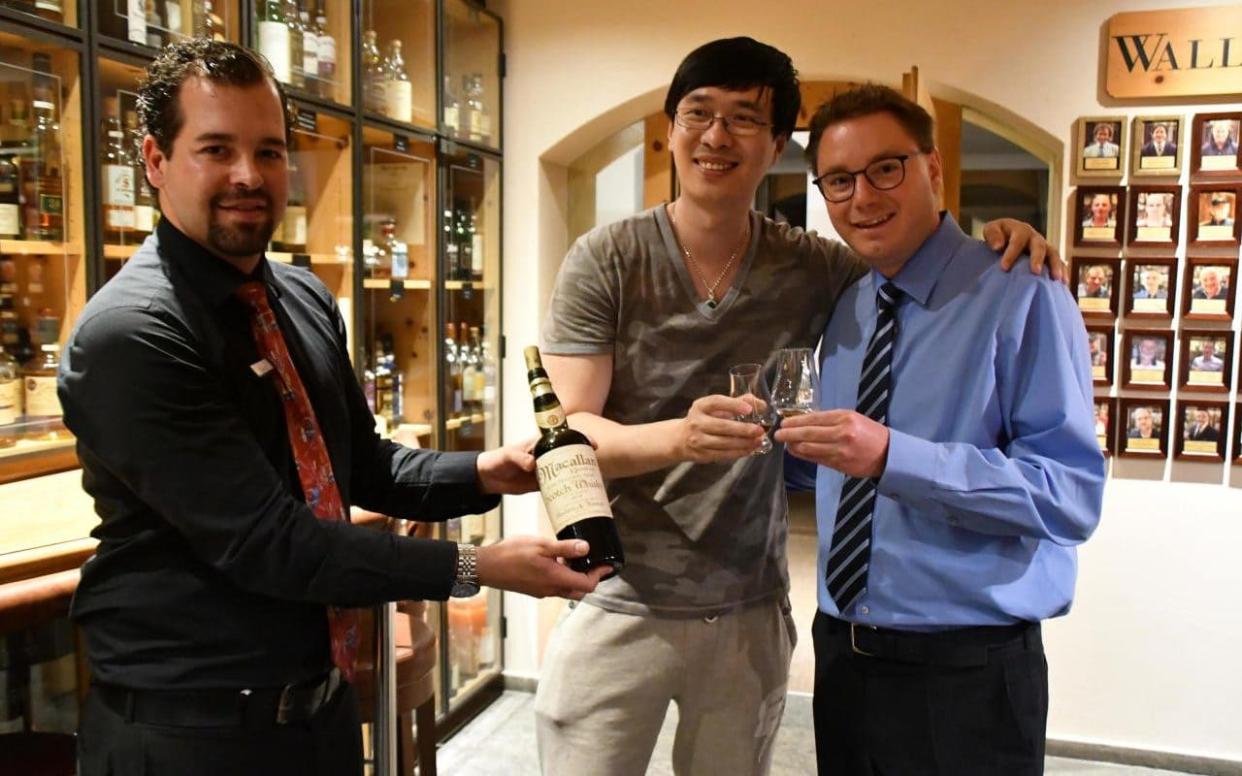 Zhang Wei, centre, splashed out £7,600 on the world's most expensive whisky shot in the Waldhaus am See hotel in St Moritz, Switzerland - Sandro Bernasconi