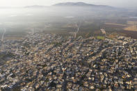In this Friday, Sept. 27, 2019 photo, A general view of the Israeli Arab village of Iksal near Nazareth, in northern Israel. Electoral gains made by Arab parties in Israel, and their decision to endorse one of the two deadlocked candidates for prime minister, could give them new influence in parliament. But they also face a dilemma dating back to Israel's founding: How to participate in a system that they say relegates them to second-class citizens and oppresses their Palestinian brethren in Gaza and the occupied West Bank. (AP Photo/Oded Balilty)
