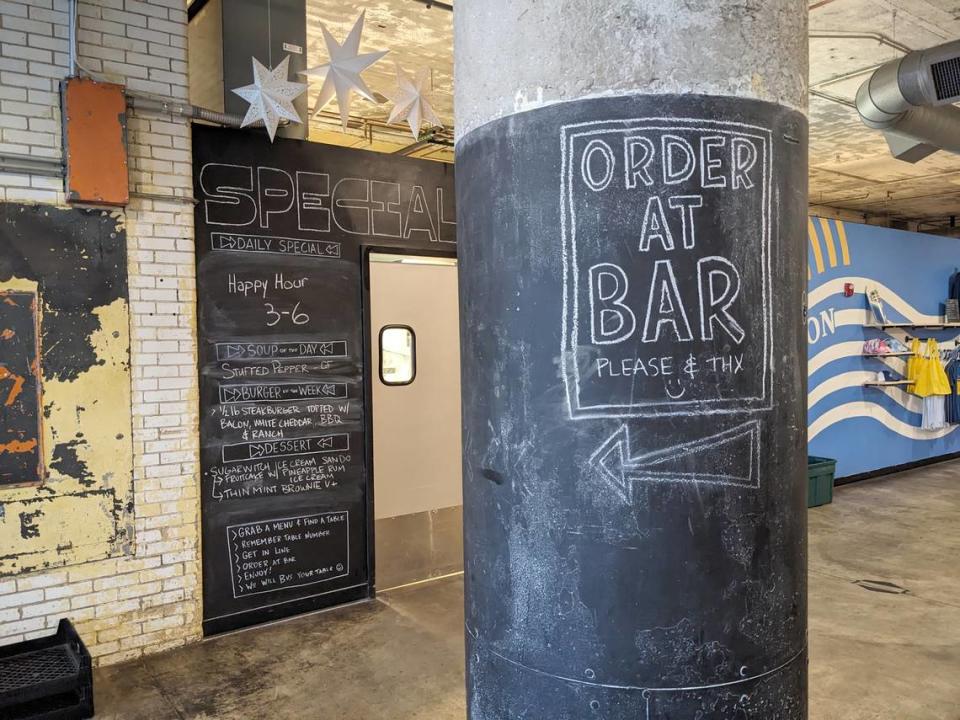 Concrete pillars in Old Bakery Beer’s dining area guide customers to the bar to place orders. The specials are listed on the wall.
