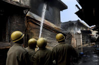 Fire fighters douse a fire at Gokul Puri tyre market which was burnt Tuesday in New Delhi, India, Wednesday, Feb. 26, 2020. At least 20 people were killed in three days of clashes in New Delhi, with the death toll expected to rise as hospitals were overflowed with dozens of injured people, authorities said Wednesday. The clashes between Hindu mobs and Muslims protesting a contentious new citizenship law that fast-tracks naturalization for foreign-born religious minorities of all major faiths in South Asia except Islam escalated Tuesday. (AP Photo/Manish Swarup)