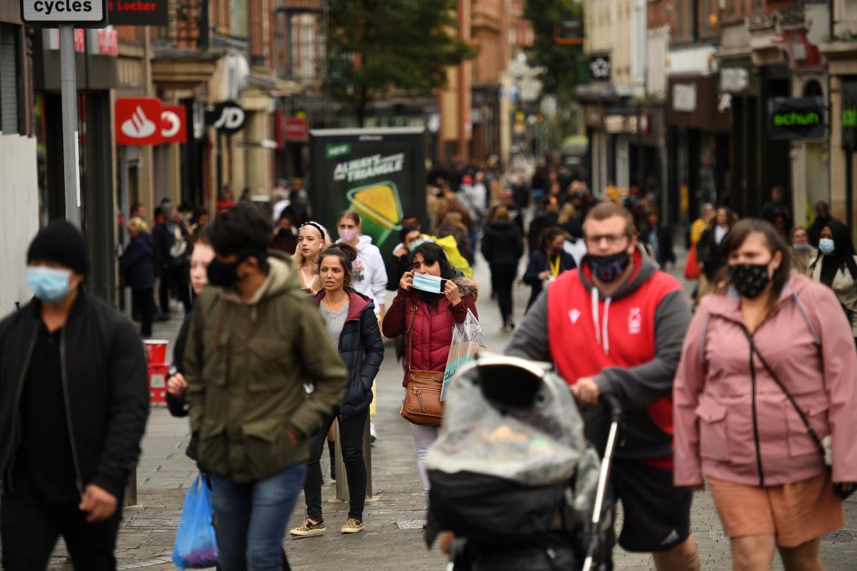 Pedestrians, many wearing protective face coverings to combat the spread of coronavirus covid-19 walk through central Nottingham in central England on October 9, 2020. - Pubs and restaurants in coronavirus hotspots look set to face fresh restrictions after Downing Street said new data suggests there is "significant" transmission taking place in hospitality settings. A "range of measures" is being looked at, with a particular focus on northern England, where it says infection rates are rising fastest. (Photo by Oli SCARFF / AFP) (Photo by OLI SCARFF/AFP via Getty Images)