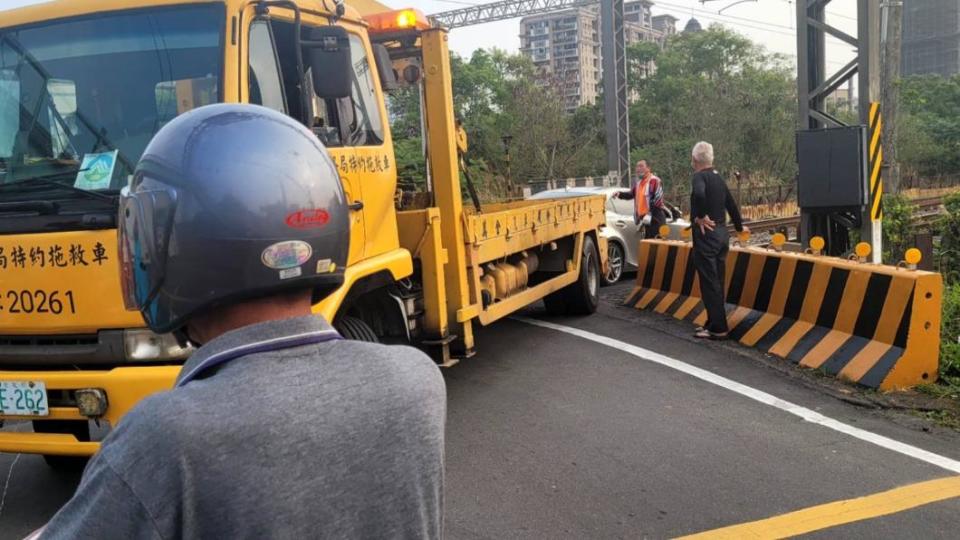 小客車在鐵軌上拋錨，被拖吊車拉離現場。（圖／翻攝自記者爆料網）