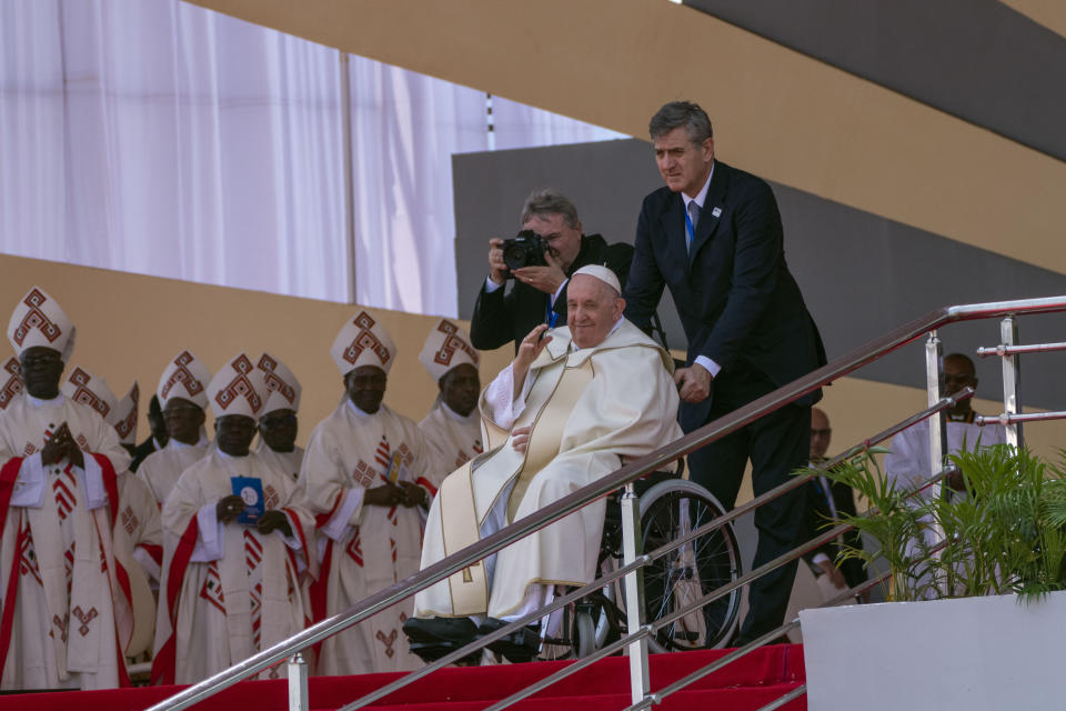 Pope Francis waves after celebrating Holy Mass at Ndolo airport in Kinshasa, Congo, Wednesday Feb. 1, 2023. Local climate activists in Congo are hoping Pope Francis' visit will help spur action to protect the country's rainforest from oil and gas interests. (AP Photo/Jerome Delay)