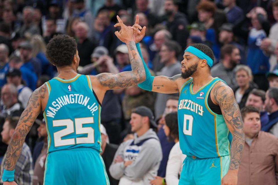 Charlotte Hornets forward P.J. Washington (25) and forward Miles Bridges (0) celebrate after the game against the Minnesota Timberwolves quarter at Target Center. Brad Rempel/USA TODAY NETWORK