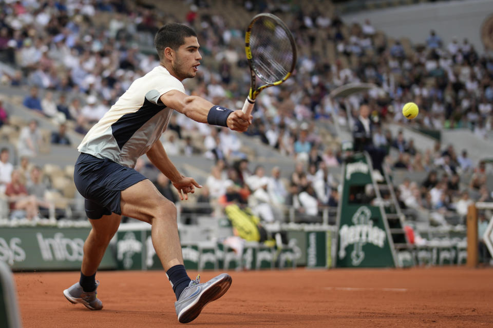 Spain's Carlos Alcaraz plays a shot against Argentina's Juan Ignacio Londero during their first round match at the French Open tennis tournament in Roland Garros stadium in Paris, France, Sunday, May 22, 2022. (AP Photo/Christophe Ena)