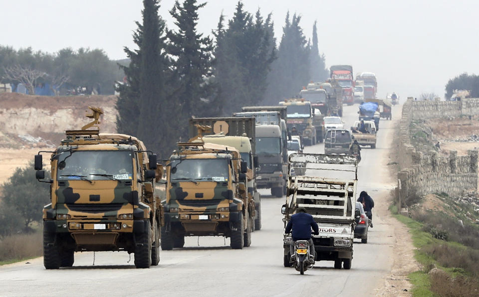 FILE - In this Friday, Feb. 28, 2020 file photo, a Turkish military convoy moves in the east of Idlib, Syria. Syria’s official news agency said Sunday, March 1, 2020, that two of its warplane were shot down by Turkish forces inside northwest Syria, amid a military escalation there that's led to growing direct clashes between Turkish and Syrian forces. SANA said the jets were targeted over the Idlib region, and that the four pilots ejected with parachutes and landed safely. (AP Photo, File)