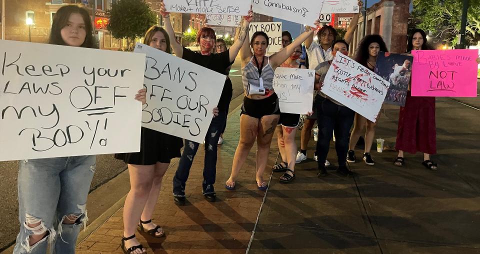 Protesters wave signs for abortion rights on Garrison Avenue just over the bridge from Oklahoma Monday night.