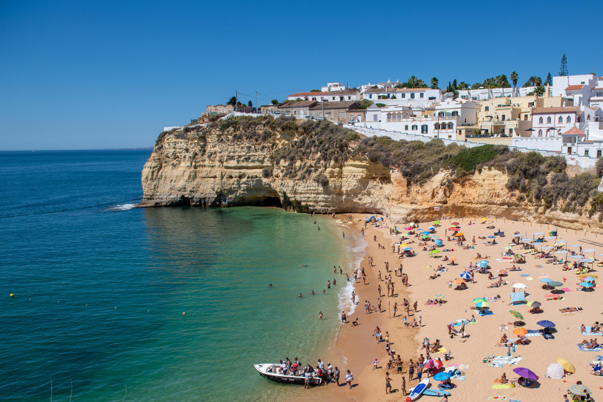 Praia do Carvoeiro, tourists enjoying the beach, turquoise sea, steep coast, rugged rocky coast of sandstone, rock formations in the sea, Lagoa Region, Algarve, Portugal. (Photo by DPPA/Sipa USA)