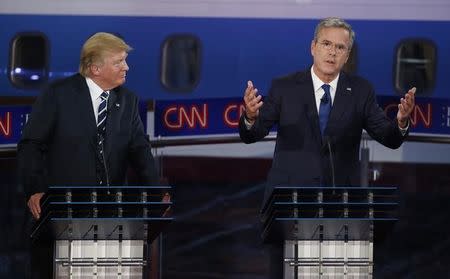 Republican U.S. presidential candidate and businessman Donald Trump (L) looks on as former Florida Governor Jeb Bush admits with apologies to his mother that he smoked marijuana in high school as he responds to a question during the second official Republican presidential candidates debate of the 2016 U.S. presidential campaign at the Ronald Reagan Presidential Library in Simi Valley, California, United States, September 16, 2015. REUTERS/Lucy Nicholson