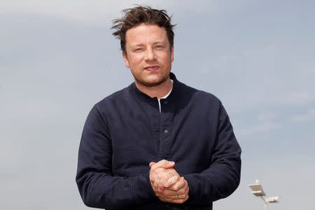 FILE PHOTO: Chef Jamie Oliver poses during a photocall at the annual MIPCOM television programme market in Cannes, France, October 15, 2018. REUTERS/Eric Gaillard/File Photo