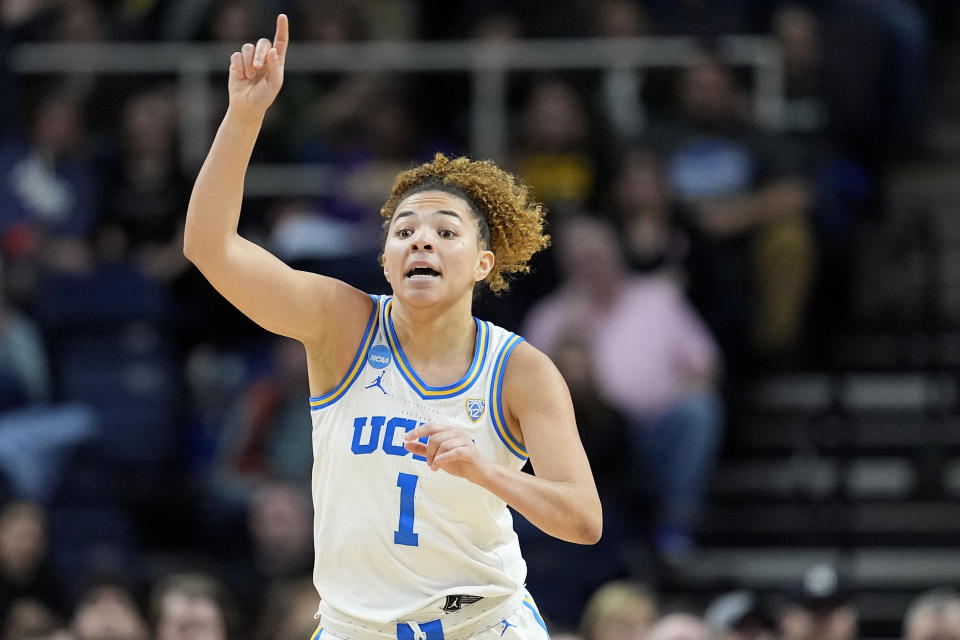 UCLA guard Kiki Rice (1) motions to teammates during the second quarter of a Sweet Sixteen round college basketball game against the LSU during the NCAA Tournament, Saturday, March 30, 2024, in Albany, N.Y. (AP Photo/Mary Altaffer)