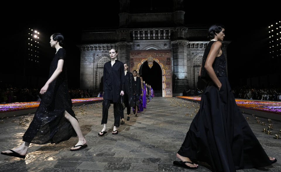 Models display creations for the Dior Pre-Fall 2023 collection at the Gateway of India landmark monument in Mumbai, India, Thursday, March 30, 2023. (AP Photo/Rafiq Maqbool)