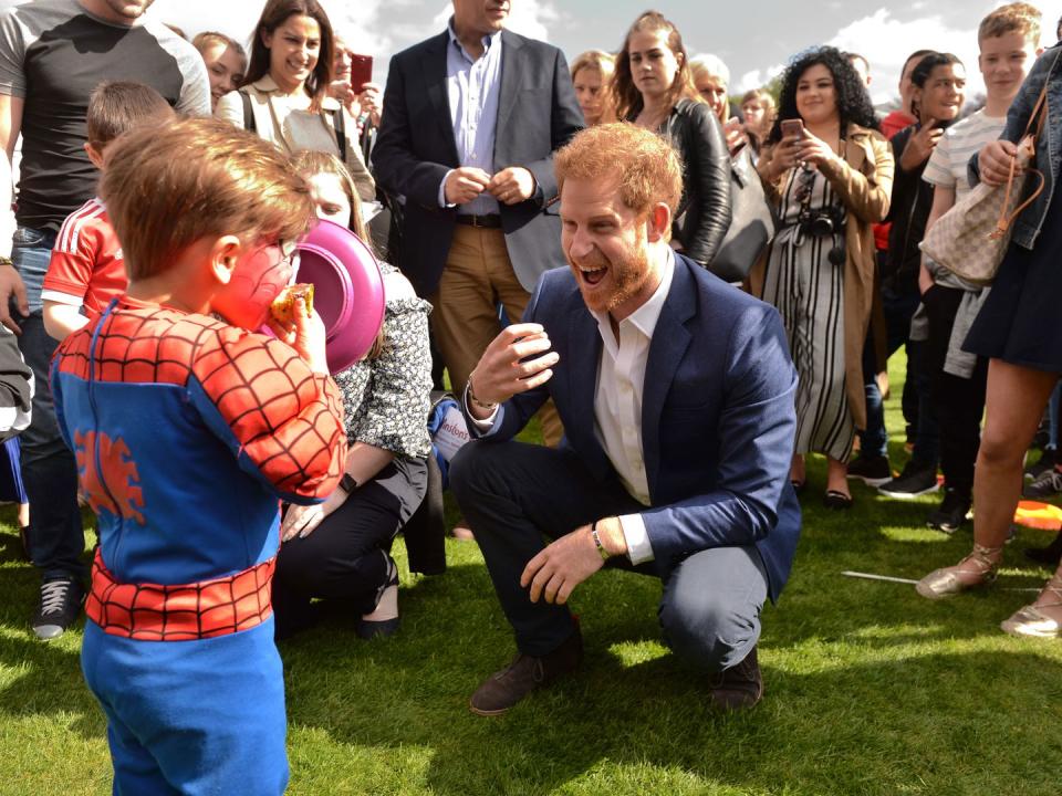 <p>Harry jokes with a boy dressed as Spider-Man during a party at the palace in 2017.</p>
