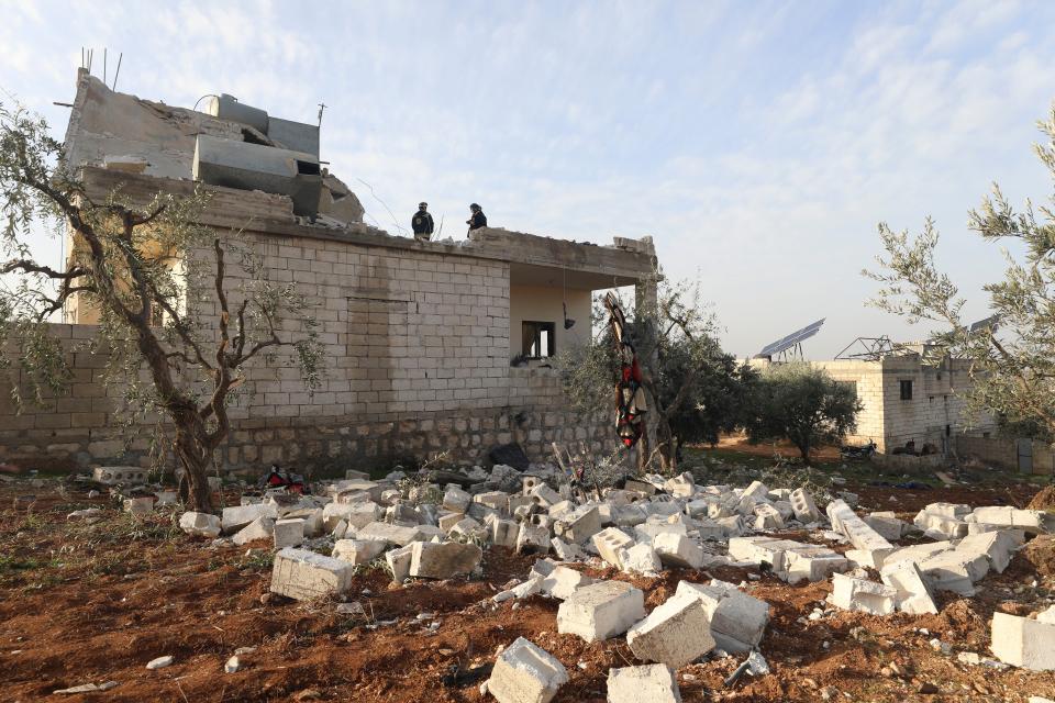 People check at a destroyed house after an operation by the U.S. military in the Syrian village of Atmeh, in Idlib province, Syria, Thursday, Feb. 3, 2022 (AP)