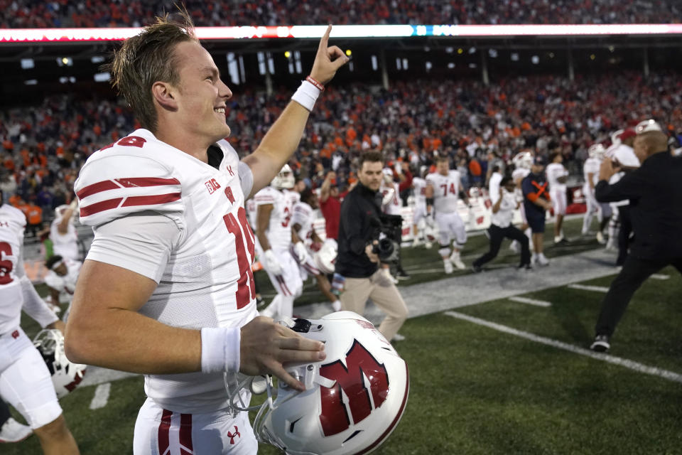 Wisconsin quarterback Braedyn Locke celebrates the team's come from behind win over Illinois after an NCAA college football game Saturday, Oct. 21, 2023, in Champaign, Ill. (AP Photo/Charles Rex Arbogast)