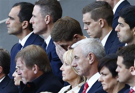 Liverpool's captain Steven Gerrard (C) reacts during a memorial service to mark the 25th anniversary of the Hillsborough disaster at Anfield in Liverpool, northern England April 15, 2014. REUTERS/Darren Staples