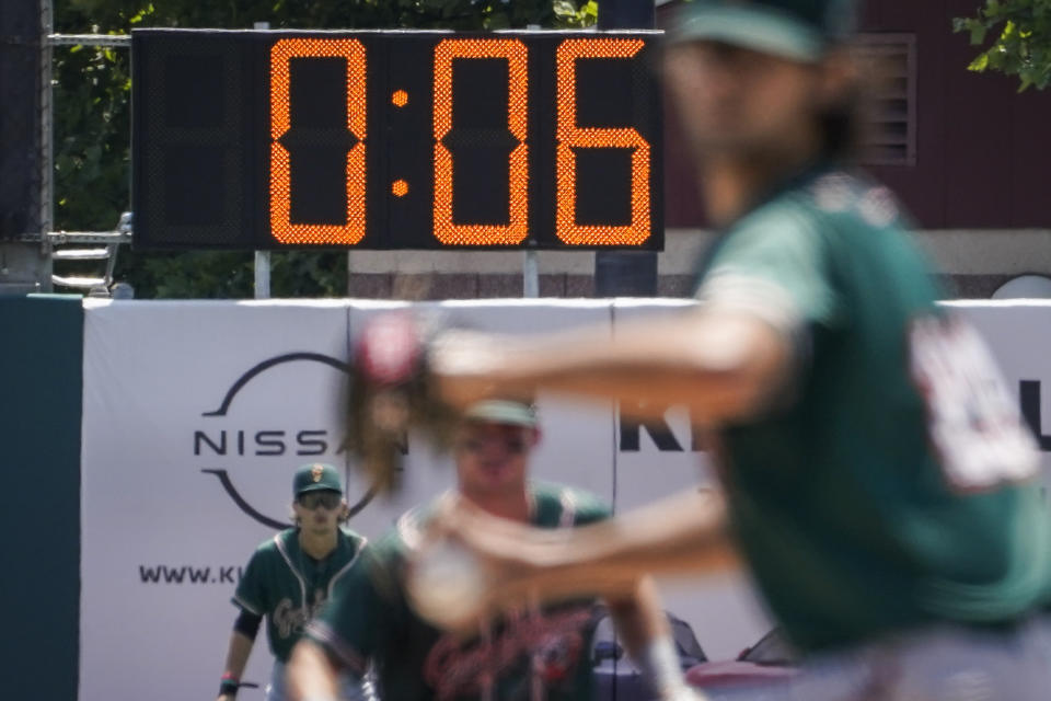 A pitch clock is deployed to restrict pitcher preparation times during a minor league baseball game between the Brooklyn Cyclones and Greensboro Grasshoppers, Wednesday, July 13, 2022, in the Coney Island neighborhood of the Brooklyn borough of New York. Major League Baseball is considering a pitch clock for next year along with shift limits, larger bases and restrictions on pickoff attempts. (AP Photo/John Minchillo)