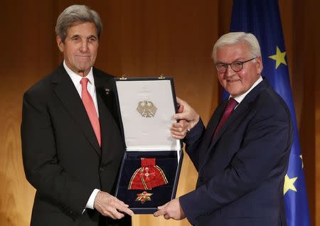 U.S. Secretary of State John Kerry receives the Grand Cross, First Class of the order of Merit of the Federal Republic of Germany from German Foreign Minister Frank-Walter Steinmeier (R) at the Foreign Ministry in Berlin, Germany, December 5, 2016. REUTERS/Fabrizio Bensch