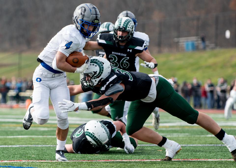 Pennridge linebacker Phil Picciotti tackles Quakertown running back John Eatherton during the annual Thanksgiving game at Helman Field in Perkasie on Thursday, November 25, 2021. The Panthers shutout the Rams 21-0.