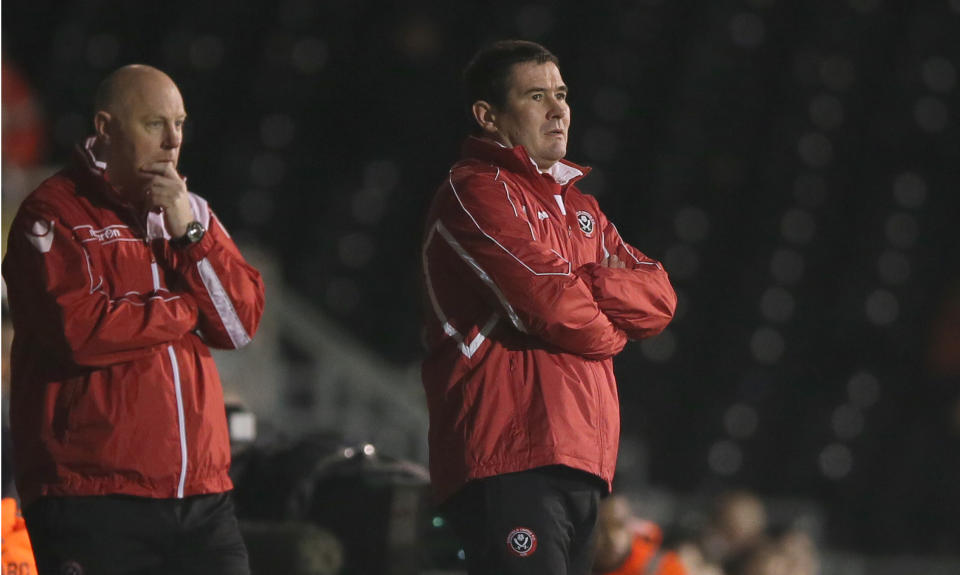 Sheffield United's manager Nigel Clough, right, watches his team from the technical area during their 4th round replay English FA Cup soccer match between Fulham and Sheffield United at Craven Cottage stadium in London, Tuesday, Feb. 4, 2014. (AP Photo/Alastair Grant)