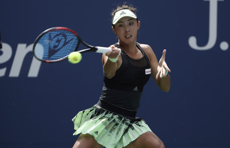 Qiang Wang, of China, returns to Ashleigh Barty, of Australia, during round four of the US Open tennis championships Sunday, Sept. 1, 2019, in New York. (AP Photo/Kevin Hagen)