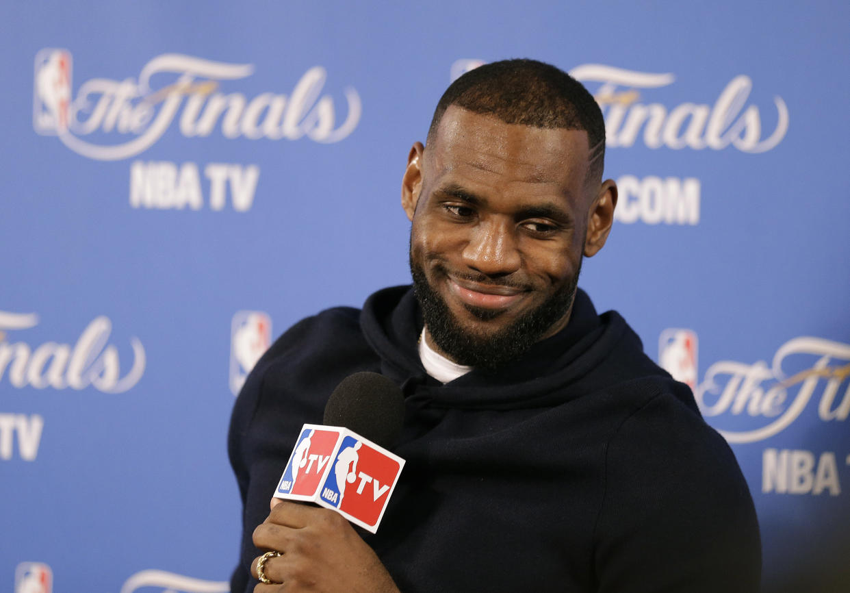 FILE - In this June 7, 2015, file photo, Cleveland Cavaliers forward LeBron James smiles during a news conference after Game 2 of basketball&#39;s NBA Finals in Oakland, Calif. Two people familiar with the negotiations say LeBron James has agreed to a one-year, $23 million contract with the Cavaliers for next season. The deal includes a player option for 2016-17. The people spoke to The Associated Press on condition of anonymity Thursday because the contract has not been signed. James has informed the team he will return. (AP Photo/Ben Margot, File)