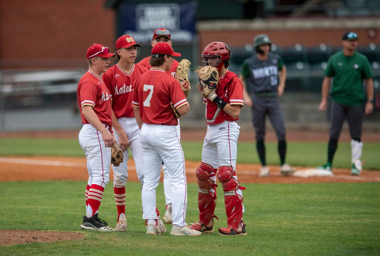 The Mater Dei Wildcats gather at the mound as they play the North Huskies at Bosse Field in Evansville, Ind., Thursday, April 25, 2024.