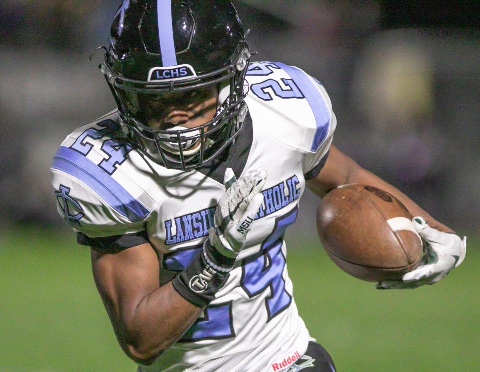 Lansing Catholic's Brandon Lewis runs for a touchdown in the second quarrter of the game at Fowlerville Friday, Oct. 14, 2022.