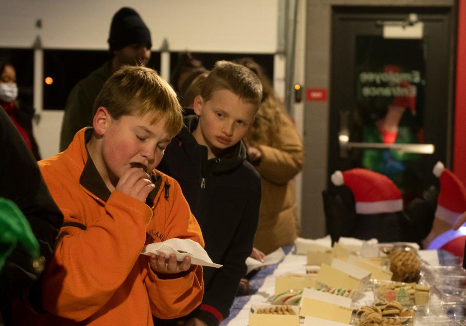 Conner Teuton, 14, tests out a cookie as his brother, Cole Teuton, 11, watches while in line for cookies and hot chocolate at the Streetsboro Fire Department.