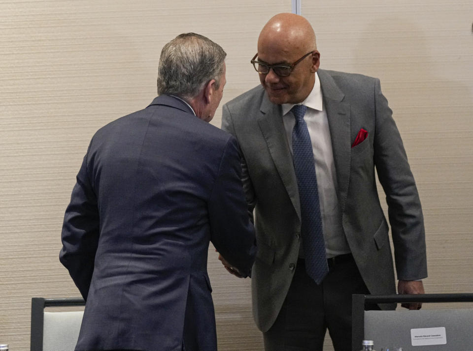 President of the National Assembly of Venezuela, Jorge Rodriguez, right, Venezuelan opposition delegate Gerardo Blyde Perez shake hands after signing an agreement to create a U.N.-managed fund to finance health, food and education programs for the poor during a ceremony at a hotel in Mexico City, Saturday, Nov. 26, 2022. The agreement signed by representatives of Venezuelan President Nicolás Maduro and the opposition marked the resumption of long-stalled negotiations meant to find a common path out of their country's complex crisis. The U.S. government, in response, agreed to allow oil giant Chevron to pump Venezuelan oil. (AP Photo/Fernando Llano)