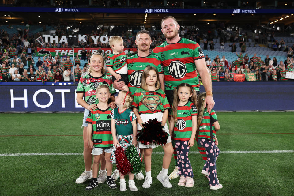 SYDNEY, AUSTRALIA - SEPTEMBER 06:  Damien Cook and Thomas Burgess of the Rabbitohs pose with family members after the round 27 NRL match between South Sydney Rabbitohs and Sydney Roosters at Accor Stadium, on September 06, 2024, in Sydney, Australia. (Photo by Matt King/Getty Images)