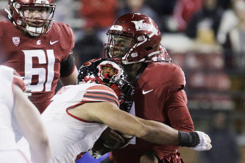 Utah defensive end Van Fillinger, front left, sacks Washington State quarterback Cameron Ward, right, during the first half of an NCAA college football game, Thursday, Oct. 27, 2022, in Pullman, Wash. (AP Photo/Young Kwak)