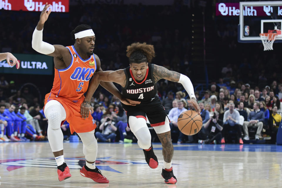 Houston Rockets guard Jalen Green (40 pushes past Oklahoma City Thunder forward Luguentz Dort (5) in the first half of an NBA basketball game, Wednesday, Feb.15, 2023, in Oklahoma City. (AP Photo/Kyle Phillips)