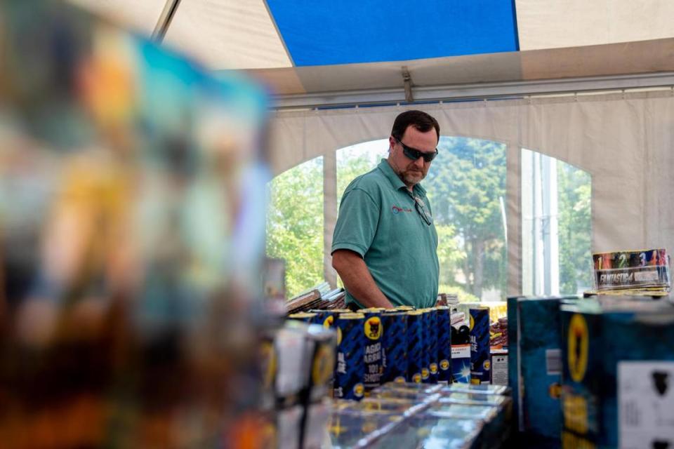 Jon Ashlock looks through the fireworks selection at the Black Cat Fireworks pop-up shop at 5524 Soundview Dr. in Gig Harbor, Wash. The pop-up shop is one of many that will be affected by a fireworks ban that takes effect in Gig Harbor next year.
